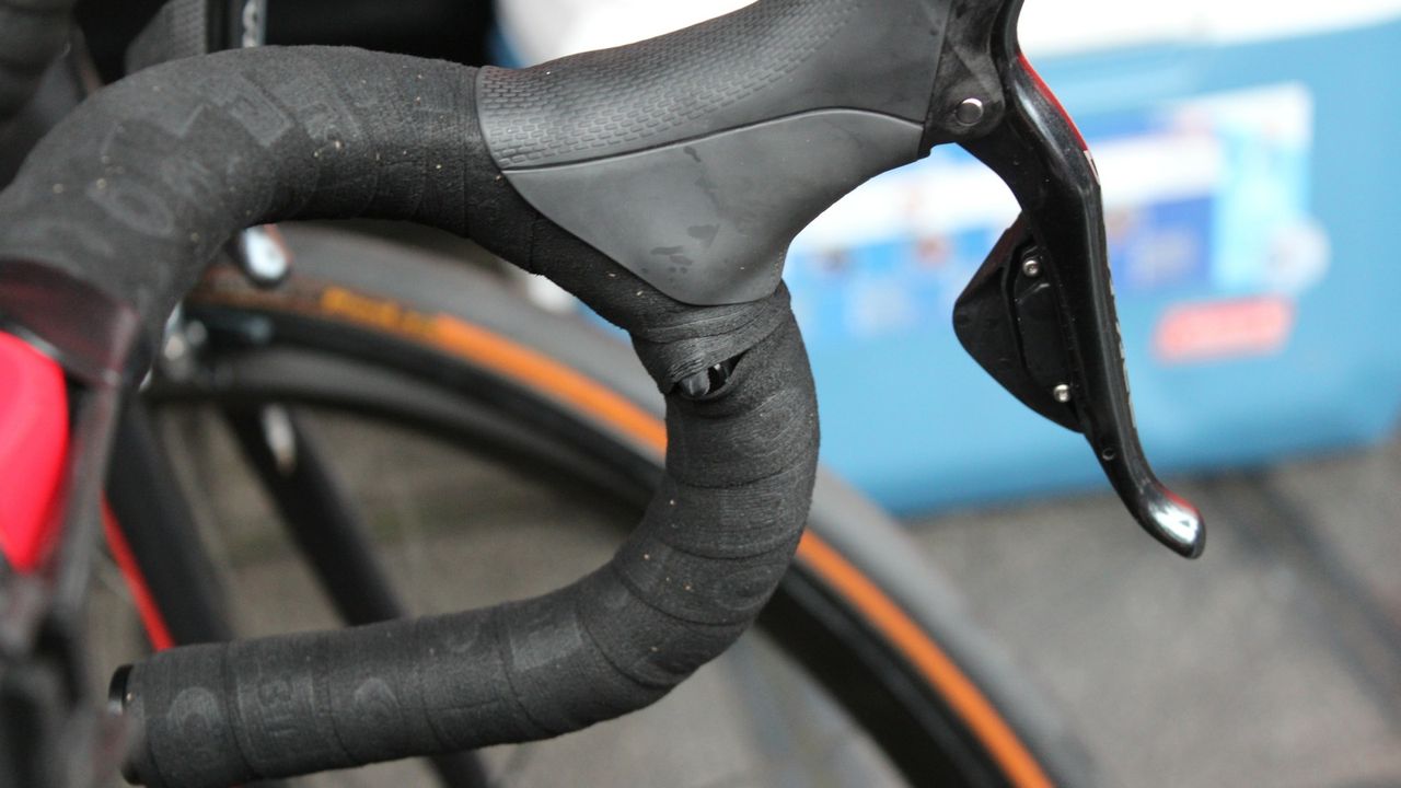 Some mechanics make a small cut in the tape, others just wrap tightly around the shifter