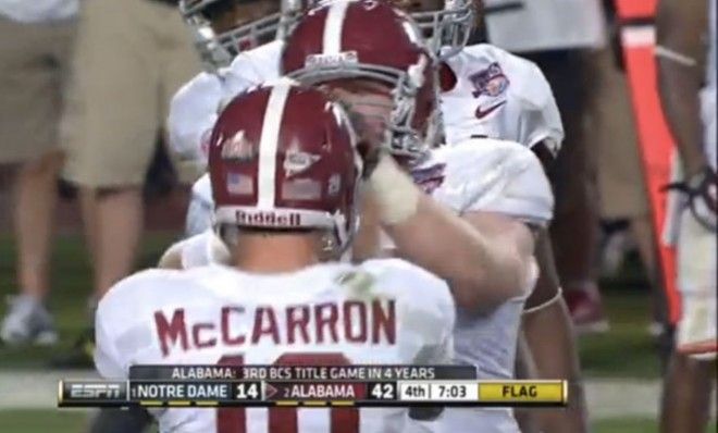 Quarterback A.J. McCarron is seen being shoved by center Barrett Jones.