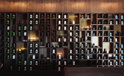 A large bespoke walnut and brass wall unit designed to display