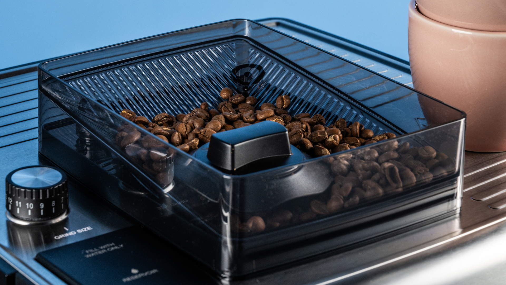 the cuisinart grind, tamp and brew espresso machine with built-in grinder photographed against a blue tom's guide background