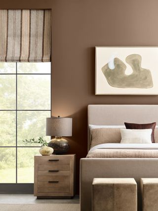 Neutral bedroom with window, side table, and bed