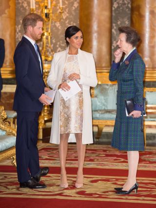 Prince Harry, Meghan Markle, and Princess Anne speak to one another at an event