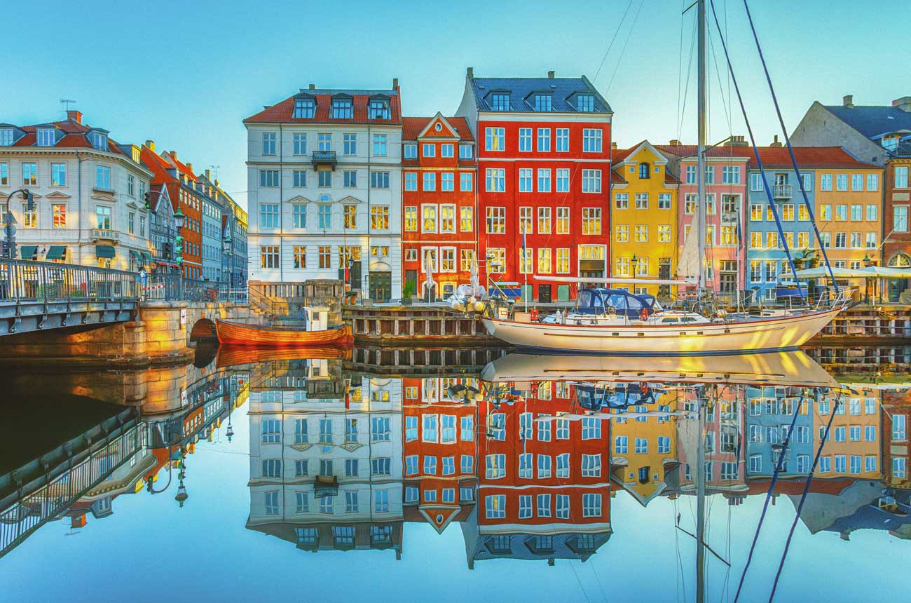 Street scene in Copenhagen with buildings reflecting in river