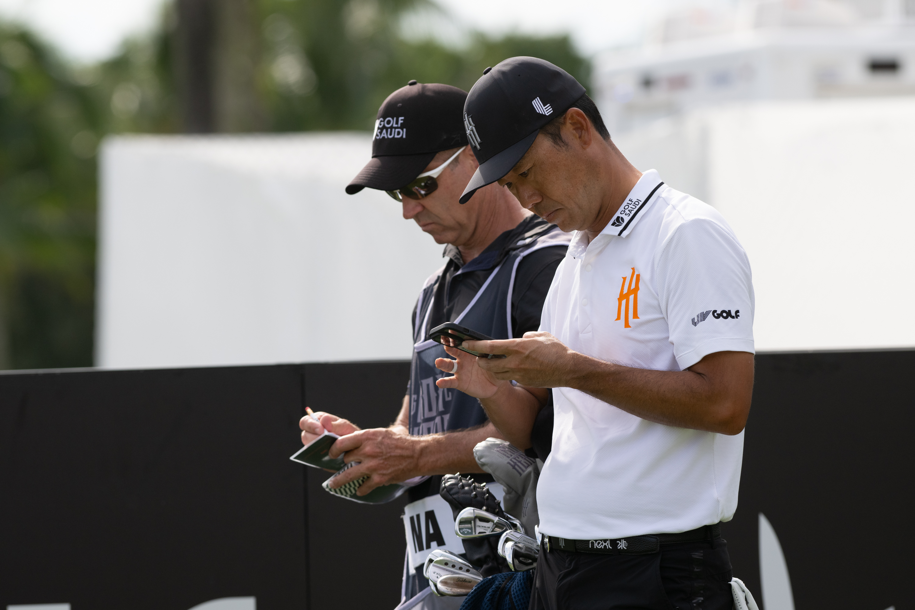Kevin Na and Kenny Harms chat during LIV Golf Miami