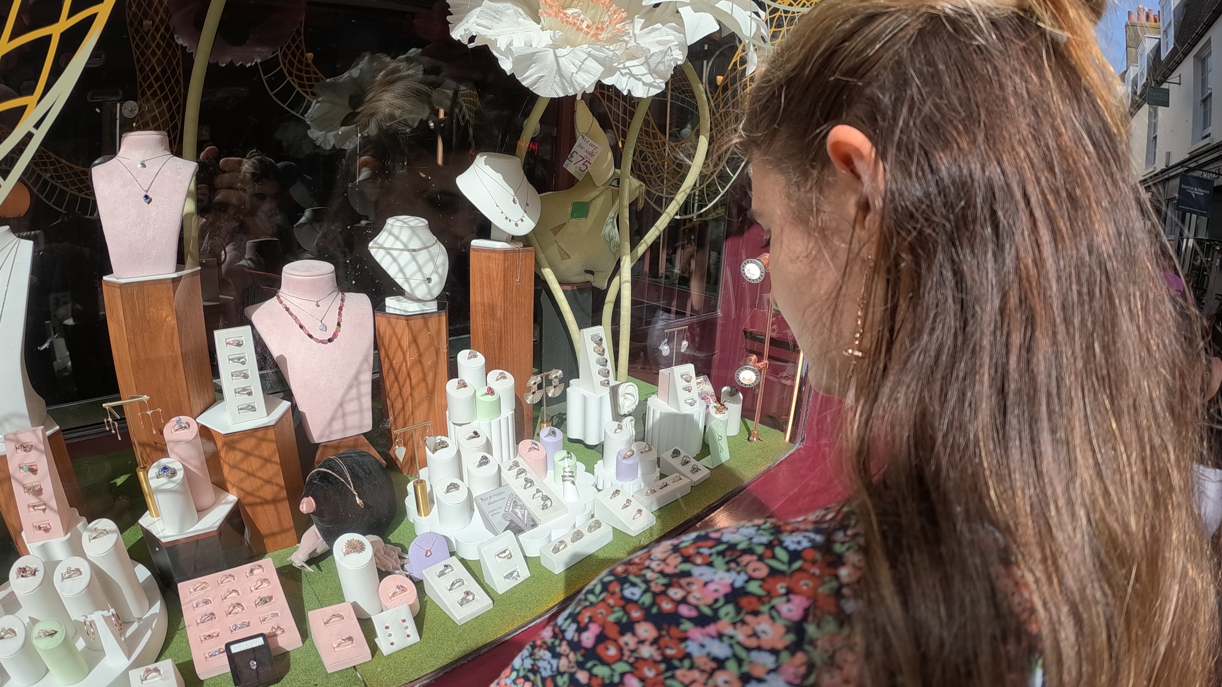 A woman looking in a ring shop window