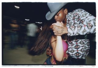 A slow shutter speed image of two people dancing