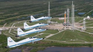 Astronauts flying jets in a formation to salute the upcoming Artemis 1 mission.