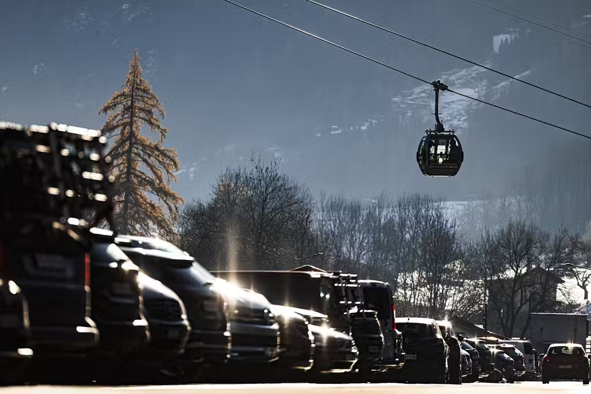 a ski lift passes over a parking lot