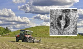 The radar scanner was mounted on a vehicle and was used to find the outline of a Viking ship buried near a previously excavated 1,500-year-old burial mound seen in the background of this photograph.