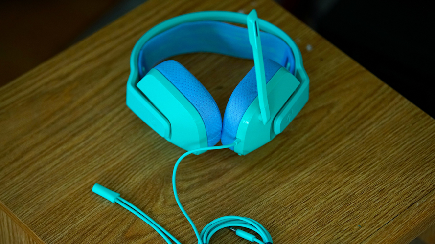 Logitech G335 on a wooden table with its cables