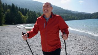 Man nordic walking on beach