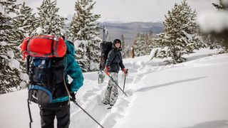 A couple snowshoeing with backpacks