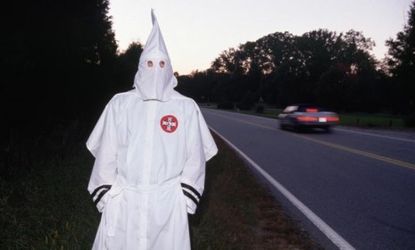 A Ku Klux Klansman stands by a North Carolina highway in 1989, after the state refused to allow the Klan to adopt a stretch of highway: Today, a Georgia KKK group is trying adopt a mile of it