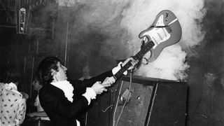 Pete Townshend performing live onstage, smashing guitar against amplifier, 13 March, 1967