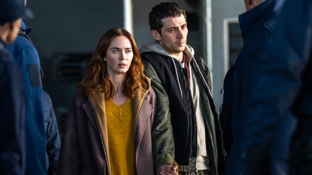 Margaret Fairchild (Emily Blunt) and Daniel Kellner (Josh O'Connor) move through a crowd in Disclosure Day.