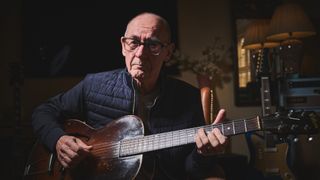 Andy Fairweather Low poses with his Gibson guitars