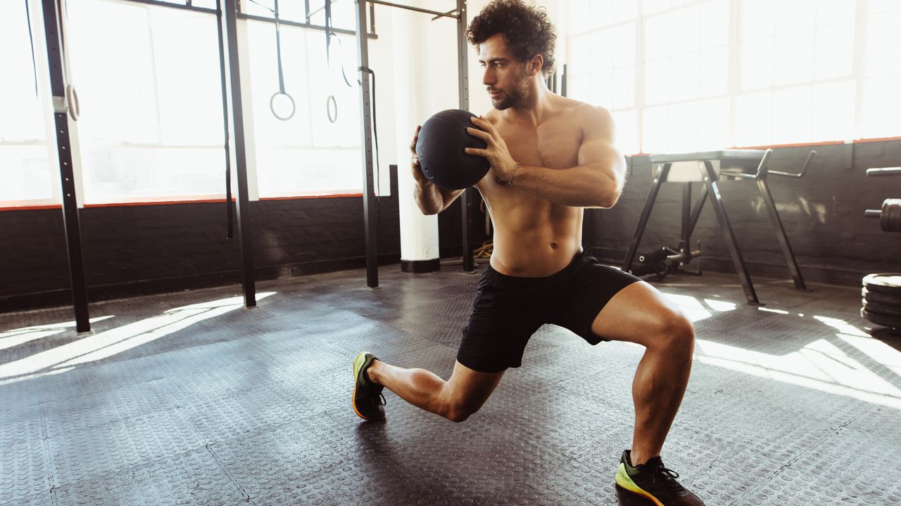 A man performing trunk rotations for his core with a medicine ball