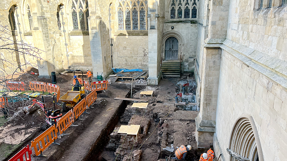 An aerial view of a cathedral undergoing an archaeological excavation. 