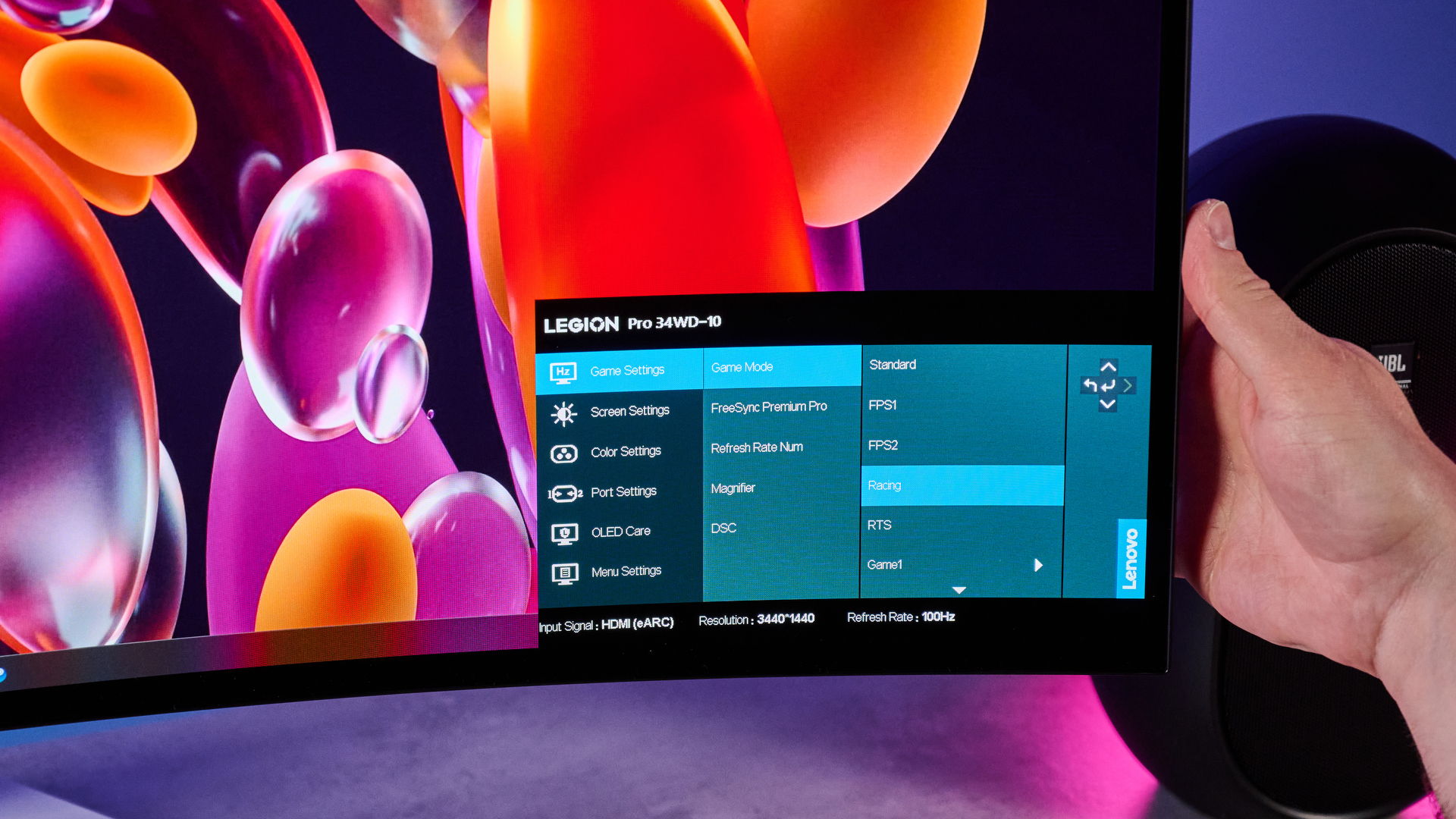 The Lenovo Legion Pro 34WD-10 gaming monitor having its settings changed