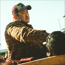 a man (don lee) presses another man into a table by his neck