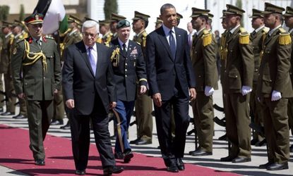 President Obama and Palestinian Authority President Mahmoud Abbas walk during an arrival ceremony on March 21 in Ramallah.