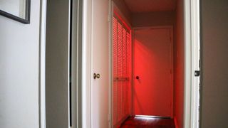 A laundry room turned red from a colored smart light bulb
