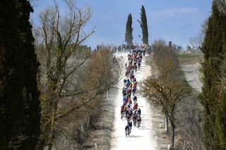 SIENA ITALY MARCH 05 The peloton passing through a gravel strokes sector during the Eroica 16th Strade Bianche 2022 Mens Elite a 184km one day race from Siena to Siena Piazza del Campo 321m StradeBianche WorldTour on March 05 2022 in Siena Italy Photo by Tim de WaeleGetty Images