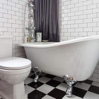 bathroom with white tiles and white bathtub