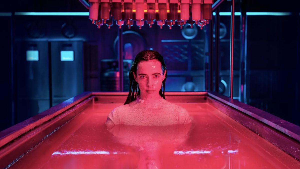 Lucy (Krysten Ritter) in a pink bath in Orphan Black: Echoes.