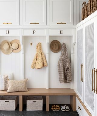 mud room with white cabinets and bench seat