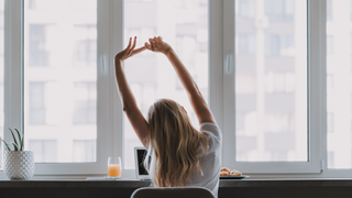 Woman stretching at desk