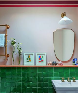 bathroom with green tiles and stripes painted on wall