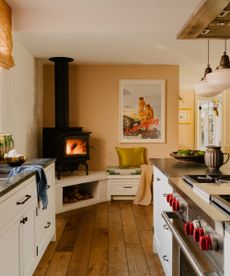 kitchen with fire in the corner and white cabinets