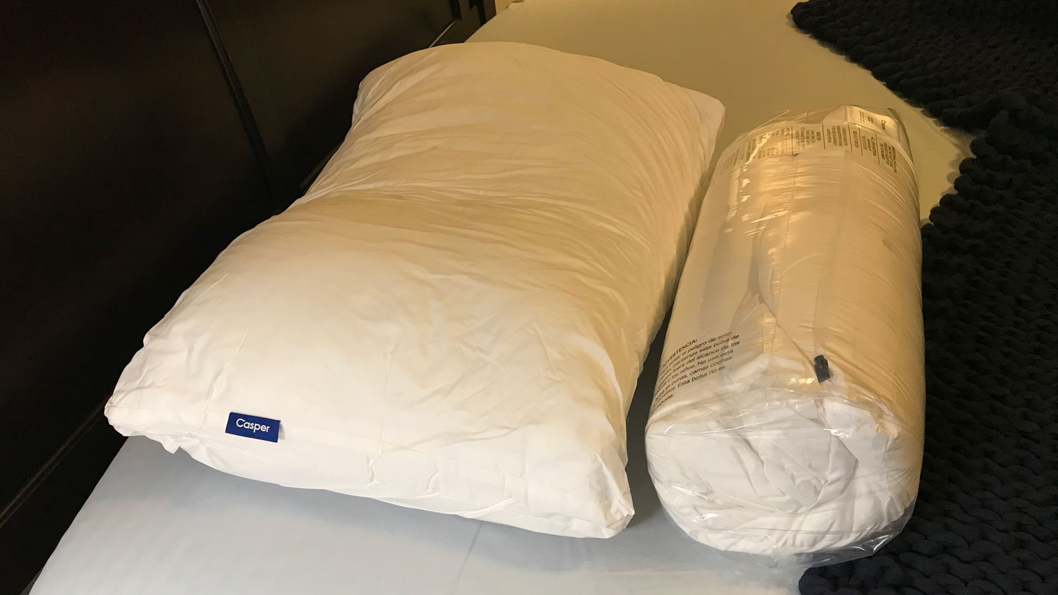 Two Casper Down Pillows, one rolled up in its shrinkwrap