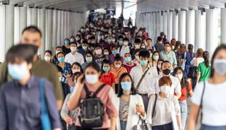 People wearing face masks in a Bangkok transportation hub in March 2020.