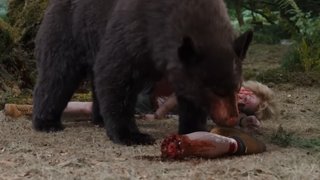 Cocaine Bear eating a person in the trailer.