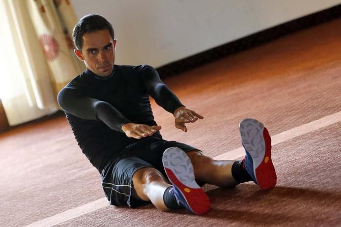 Alberto Contador does some early morning stretching