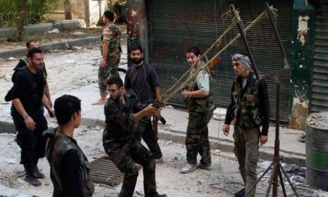 Members of the Free Syrian Army use a catapult to a launch a homemade bomb in Aleppo.