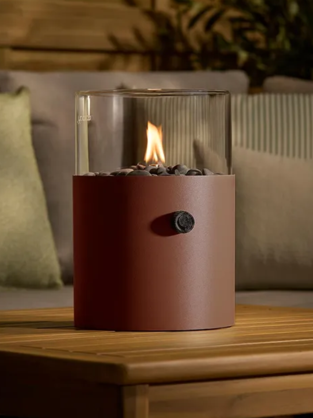 A portable outdoor fire pit in rust color