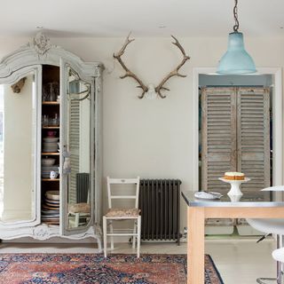 french kitchen with antlers on wall and crockery storage