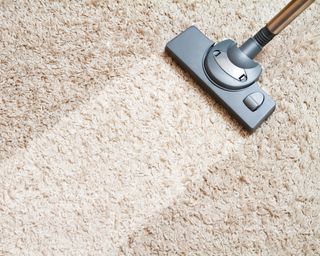 Cream deep pile carpet being vacuumed