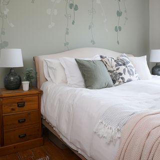 green bedroom with wall mural