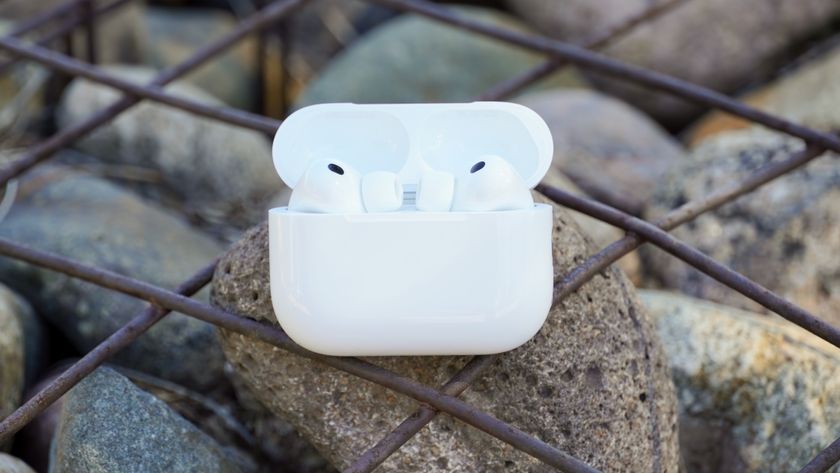 The AirPods Pro 3 with their charging case at a park. 