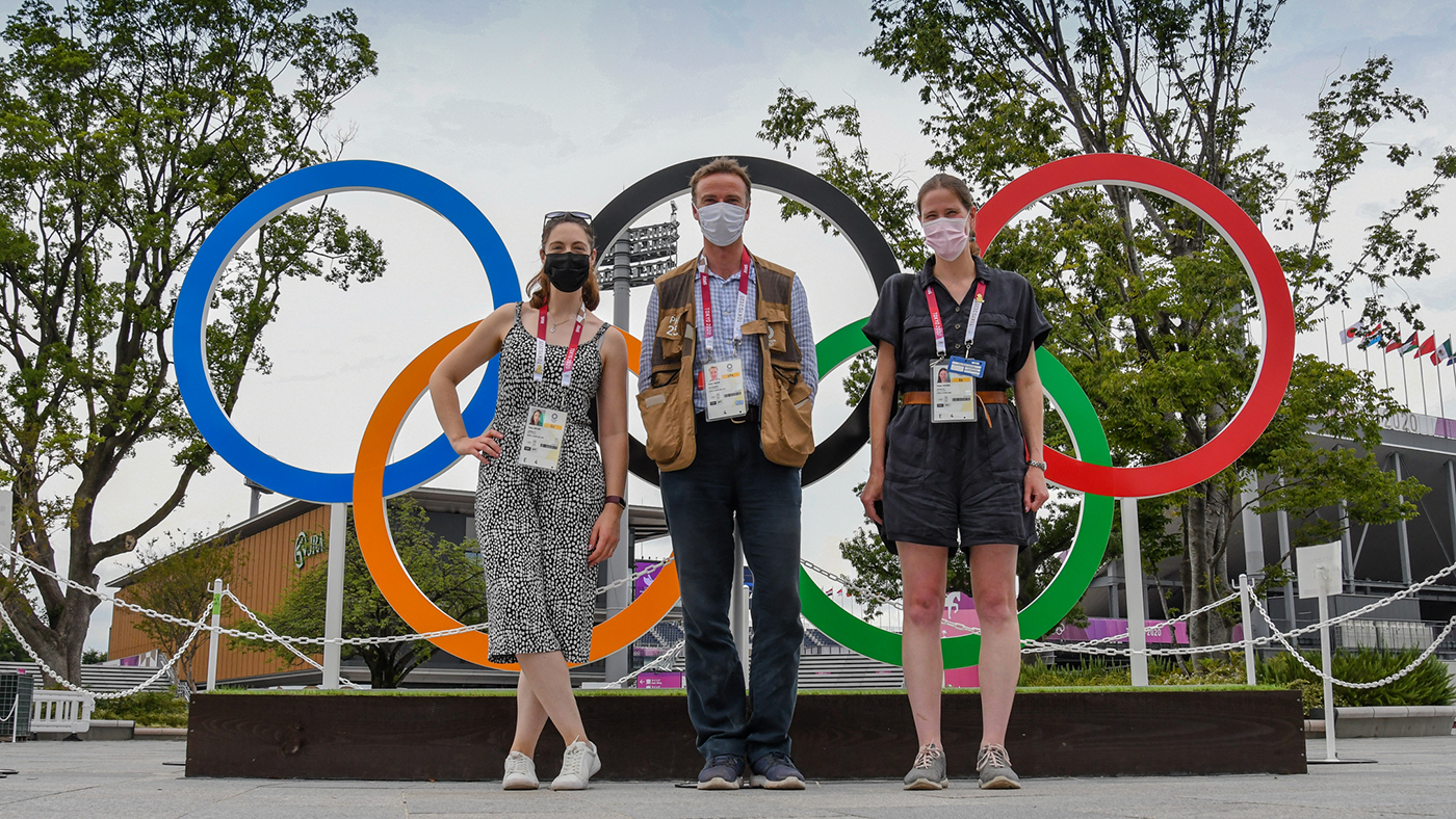 H&amp;amp;H reporter Polly Bryan, photogrpaher Peter Nixon and H&amp;amp;H reporter Pippa Roome picturesd wearing face masks standing in front of the Olympic ring at the Tokyo Games.