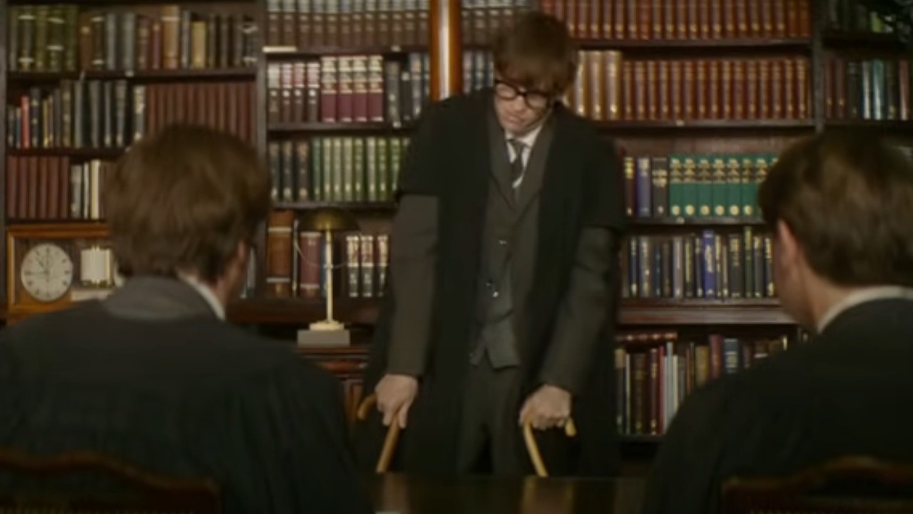 Eddie Redmayne using two canes to support himself in The Theory of Everything