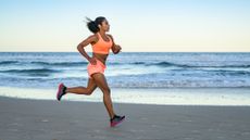 a woman running on the beach