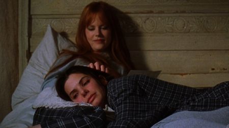 Sandra Bullock laying on Nicole Kidman in Practical Magic