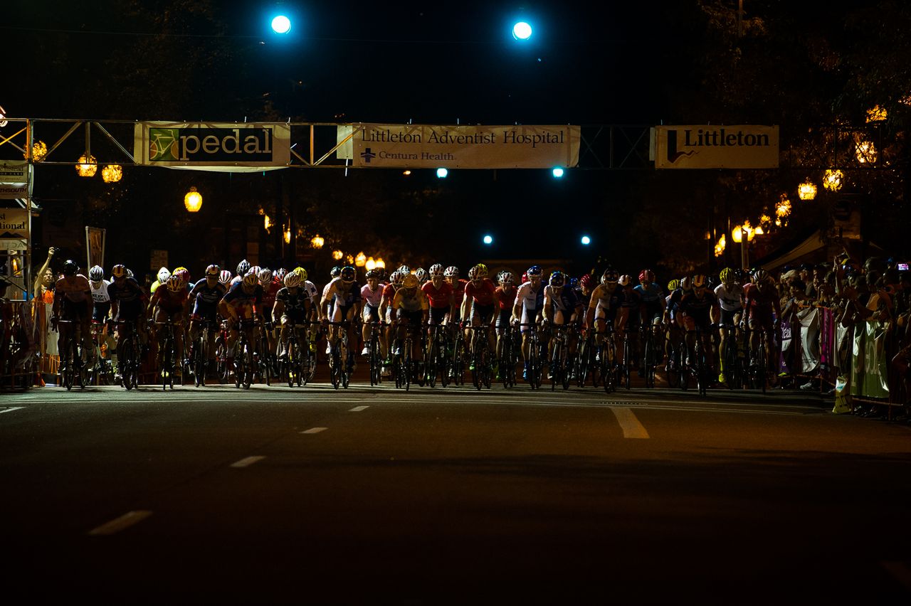 The start of the men's race through the darkened streets, with a smattering of light, of Littleton, Colorado.
