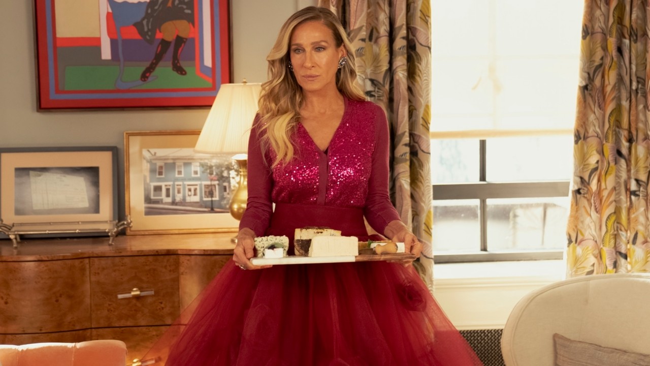 Sarah Jessica Parker holding a tray of cheese in the seires finale of And Just Like That...
