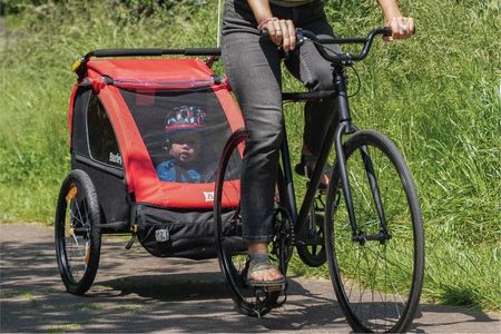 Burley Bee bike trailer being tested outdoors 